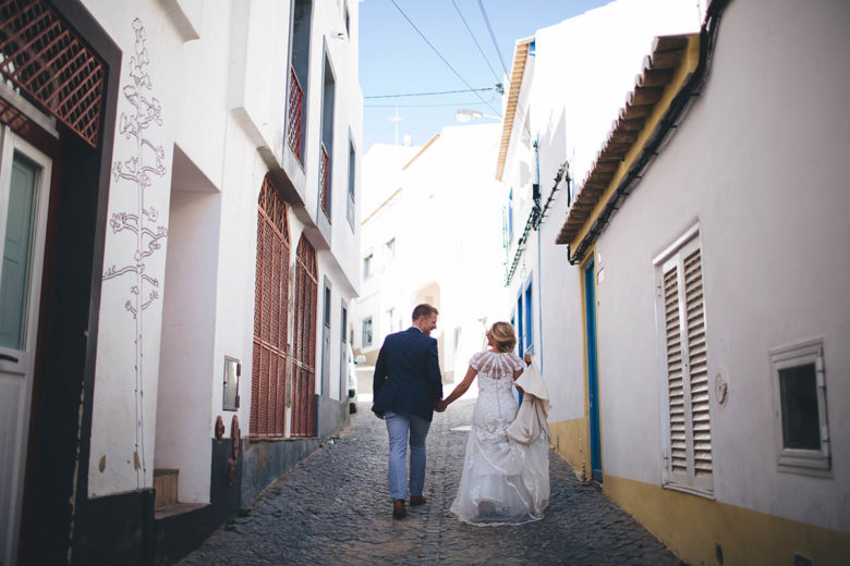 bride and groom walking through street