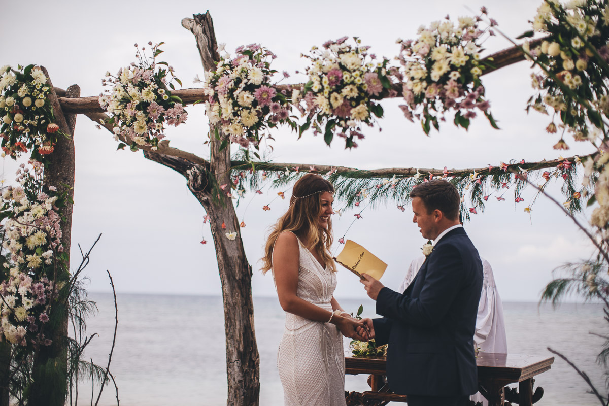 couple read their wedding vows to each other