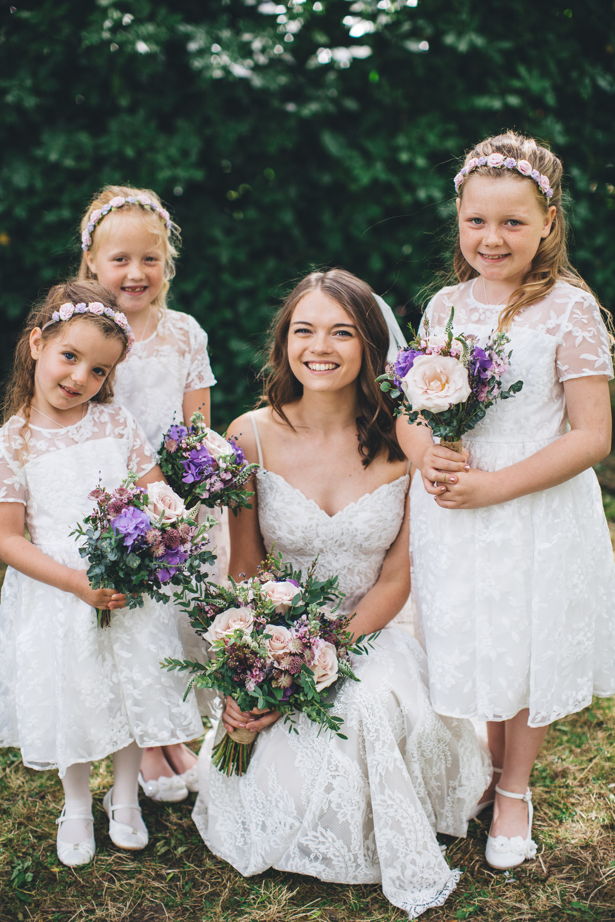 bride posses with flower girls