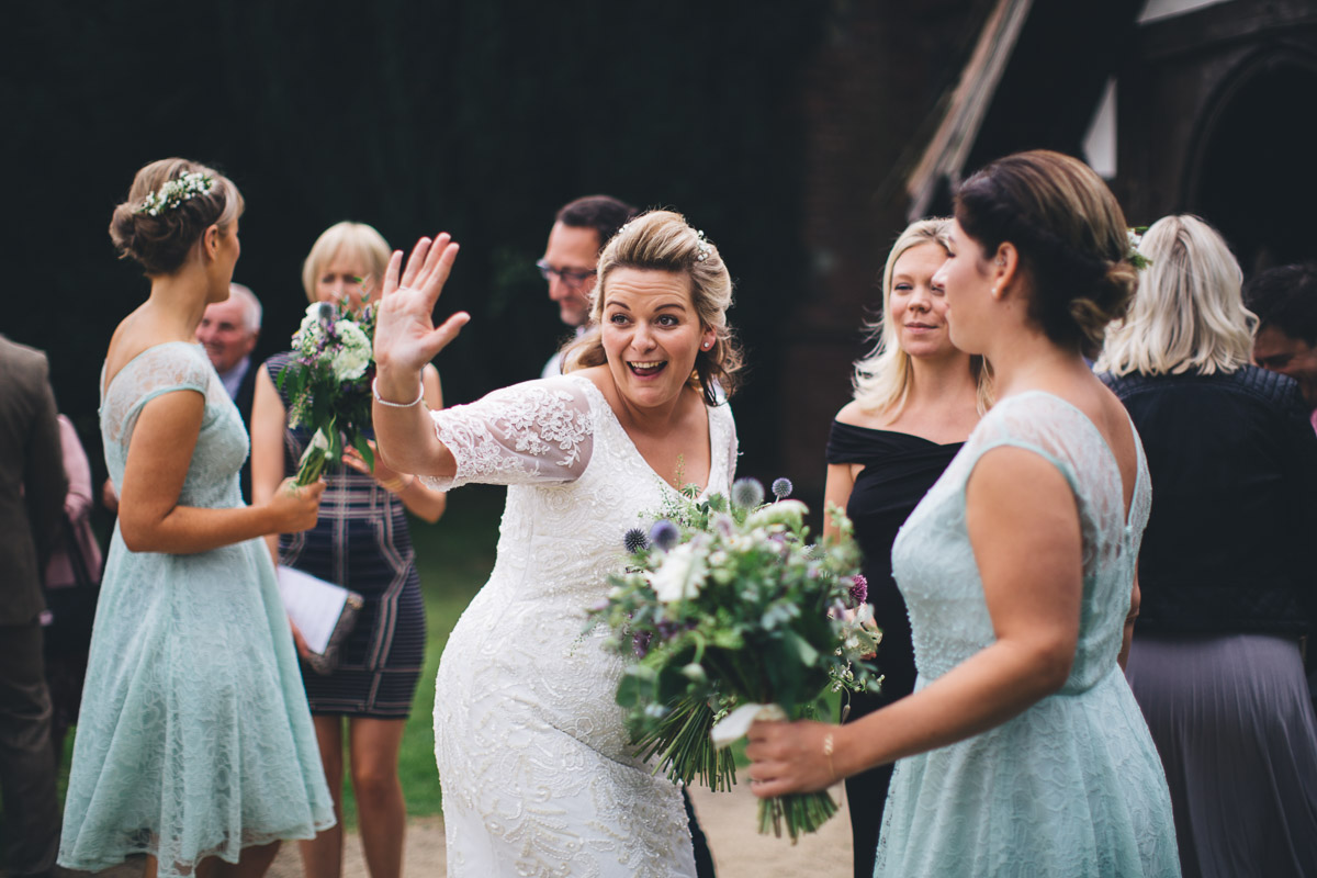 bride waving at guest