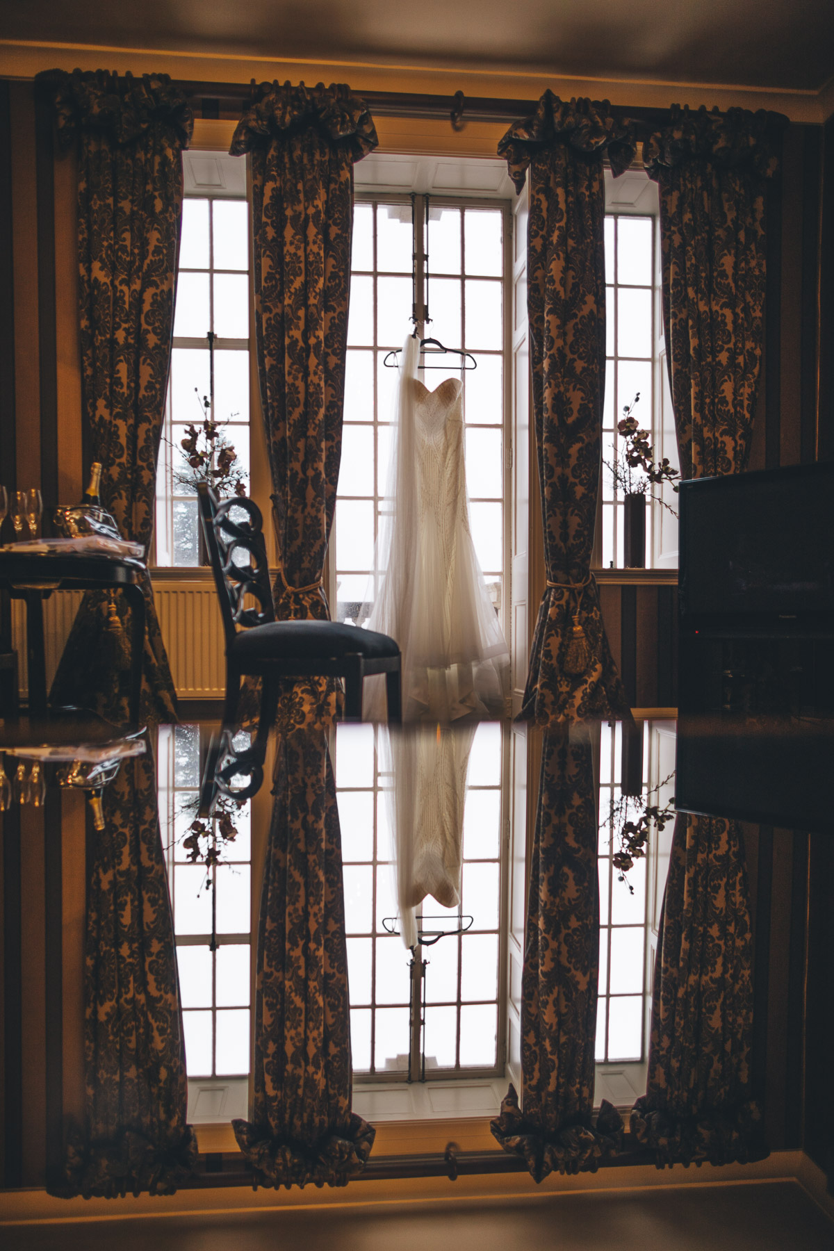 wedding dress hung in window