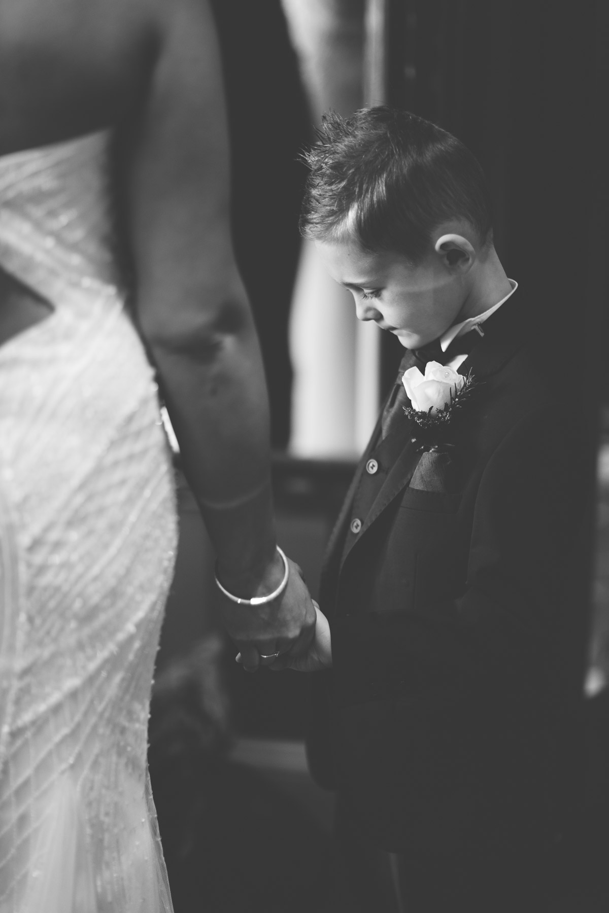 page boy holding brides hand
