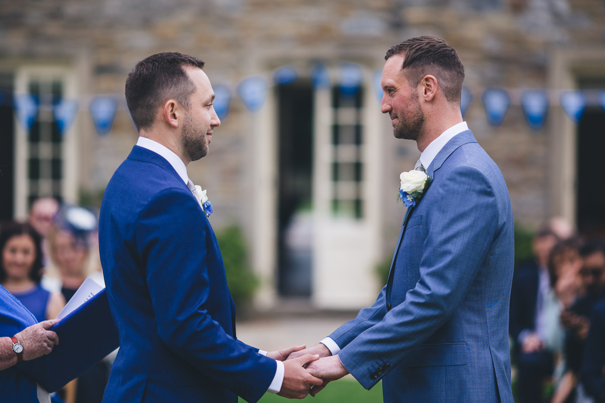 grooms facing each other 