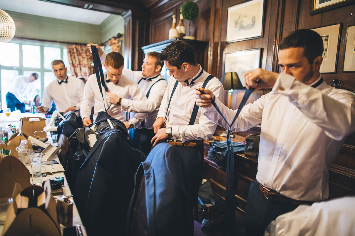 many groomsmen dressing in the dining room