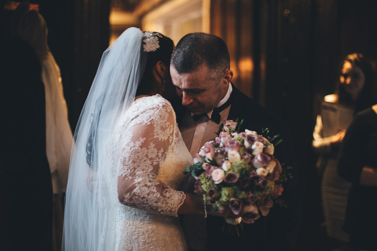 father hugs the bride