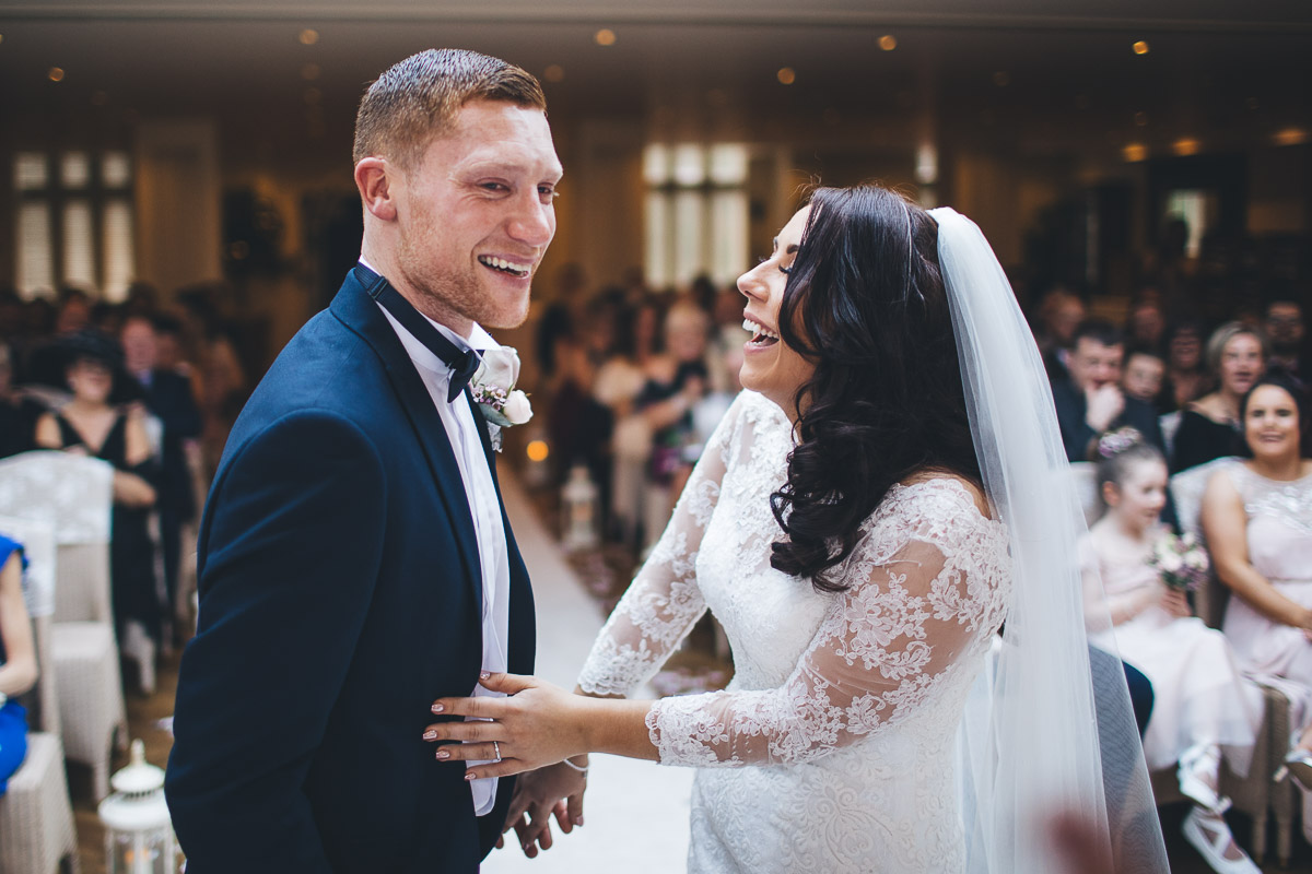 bride and groom laugh just after their first kiss
