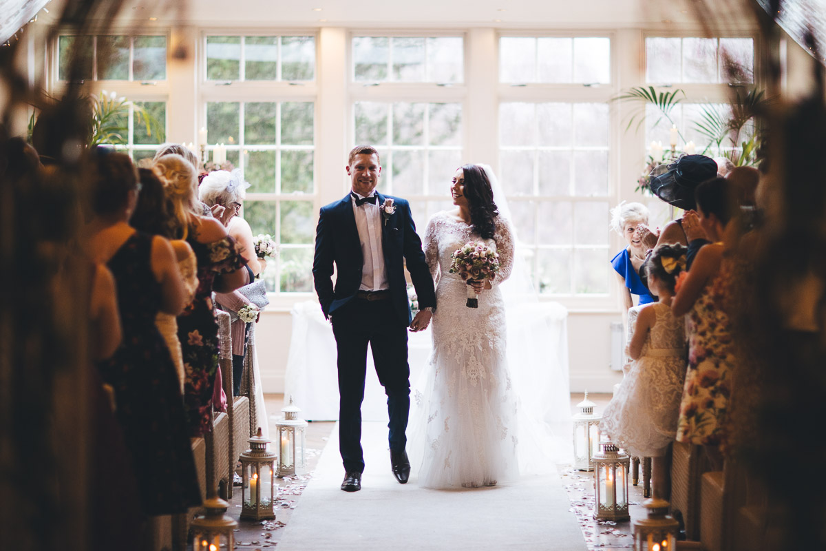 bride and groom ready to walk back down the ailse