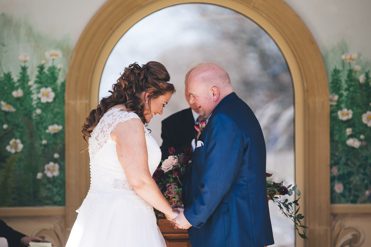 bride and groom giggle their way through the ceremony