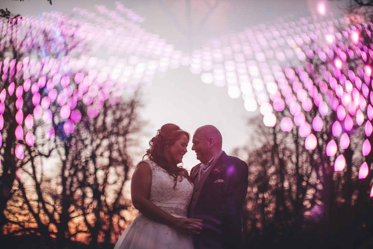 double exposure shot of bride and groom and the led dancefloor lights