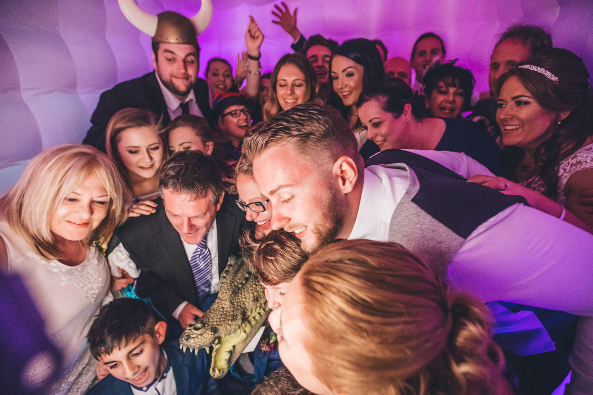 all wedding guests crammed into the photo booth