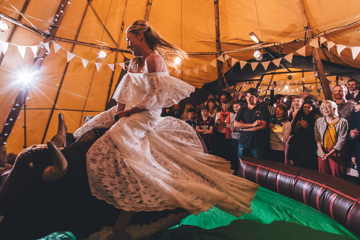 bride riding the bucking bronco inside the tipi
