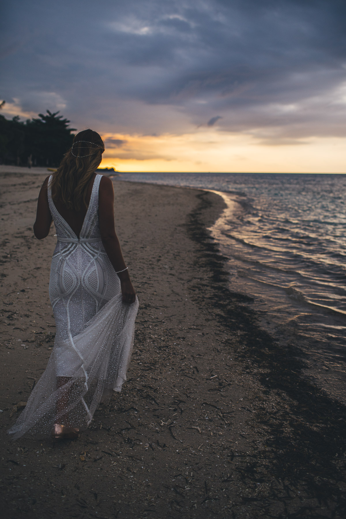 raana walking down the beach in her wedding dress