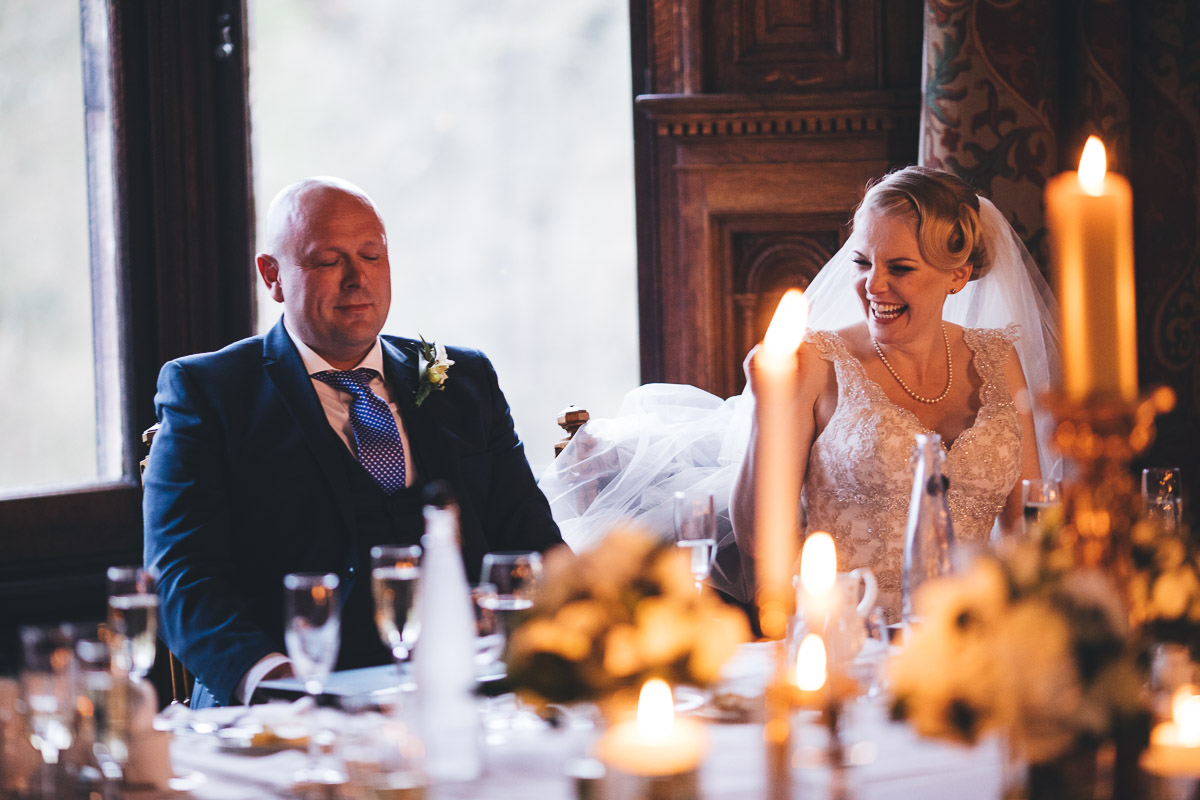 bride laughs and the groom has his eyes closed during the speeches