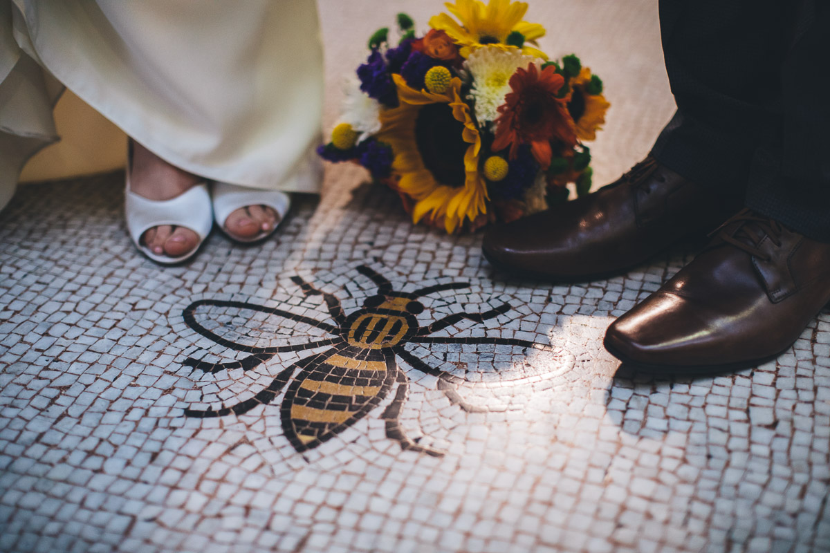 couples feet along with the Manchester bee on the floor of the town hall