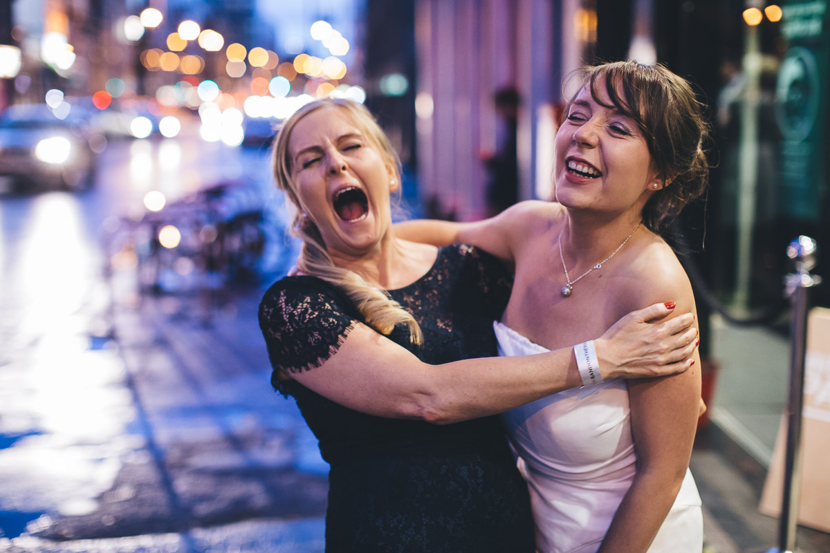 bride laughs with maid of honour