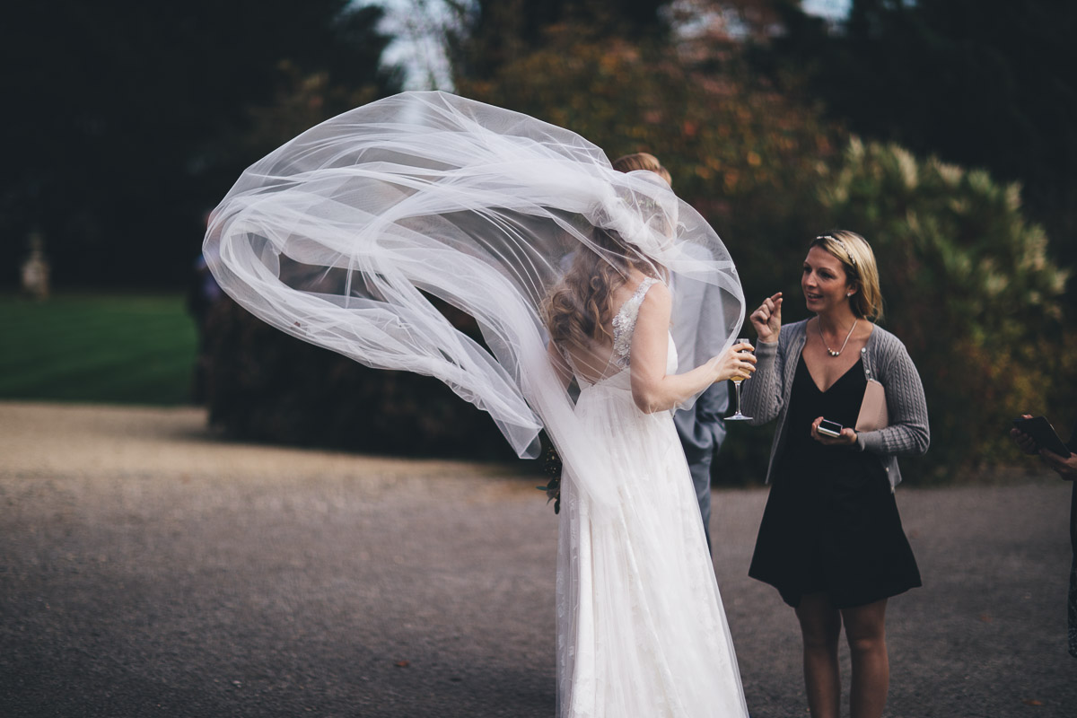 the brides veil blows up in the wind