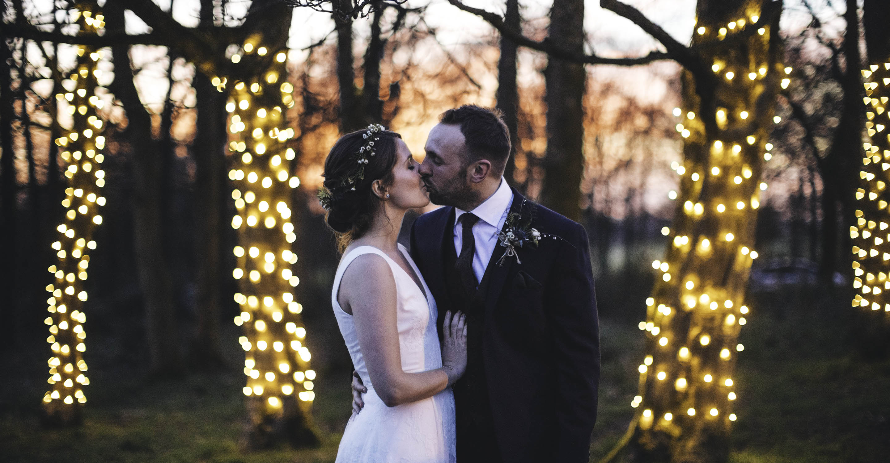 Bride and Groom kiss Woodland Fairylights trees Sunset