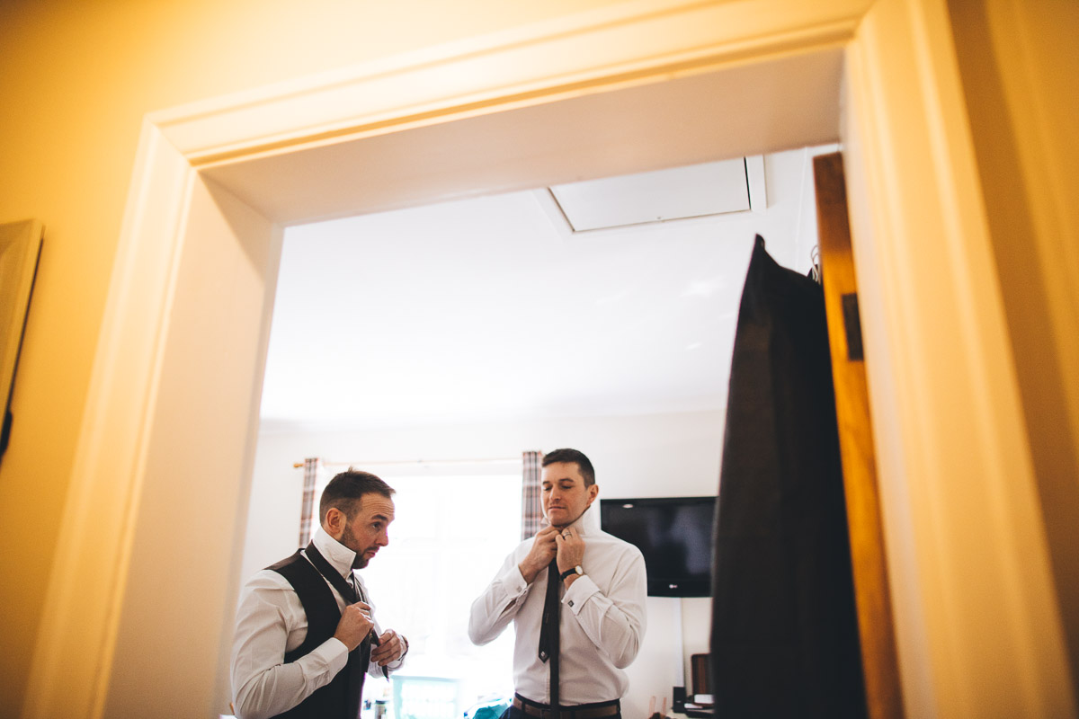 Groom Tying ties Wedding preparation shirt and tie