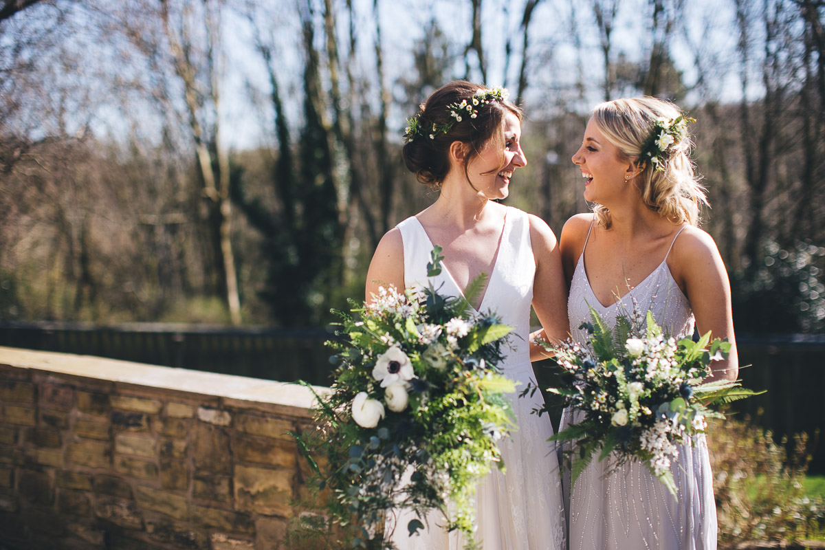 Bride and bridesmaid laughing garden Flowers