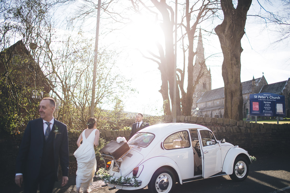 Bride and Groom getting into wedding car Just Married VW Beetle