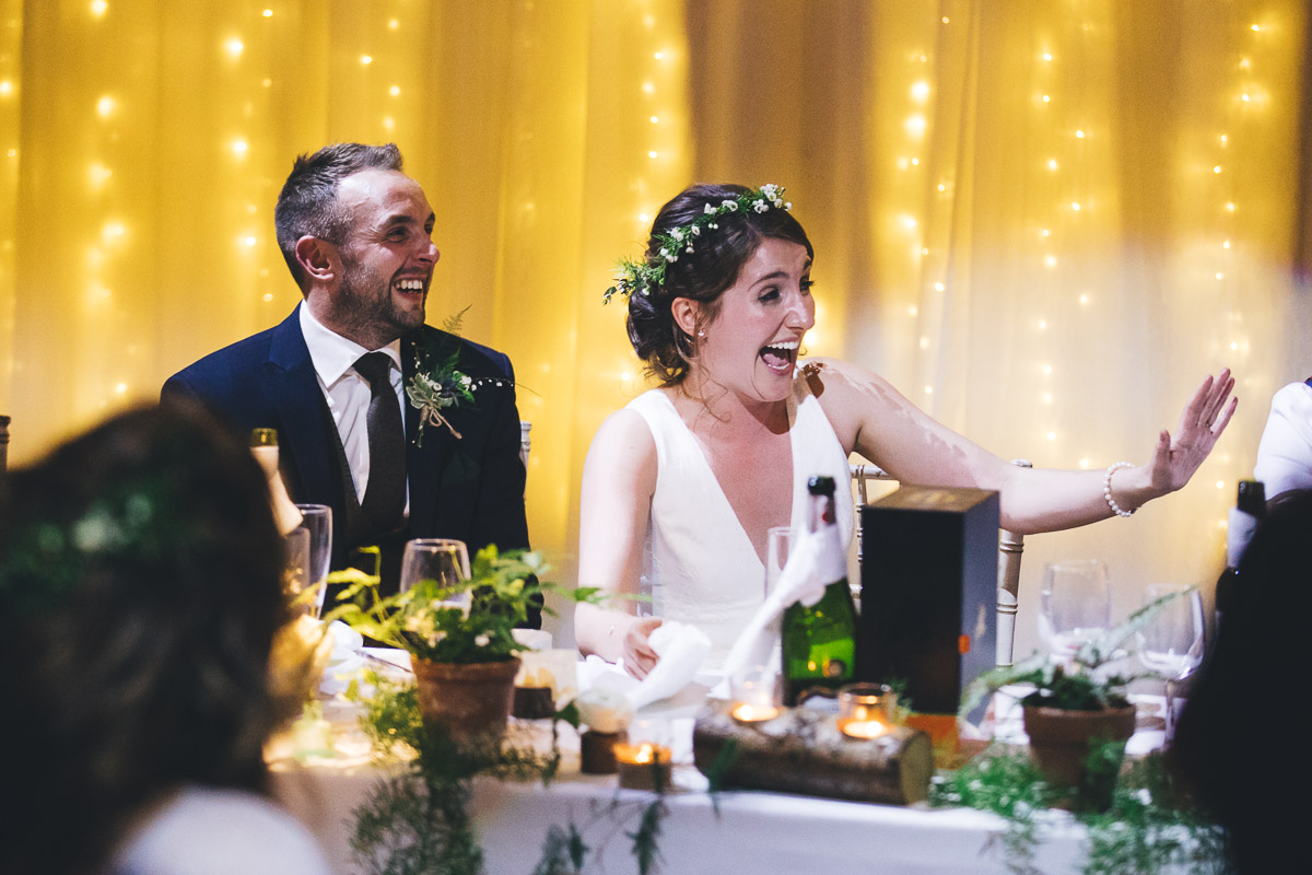 Bride and Groom Smiling and laughing Fairylights Plants Candles