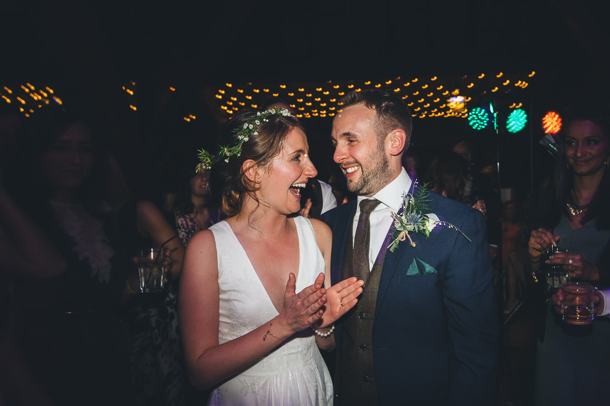Bride and Groom smiling Dancefloor evening Disco lights