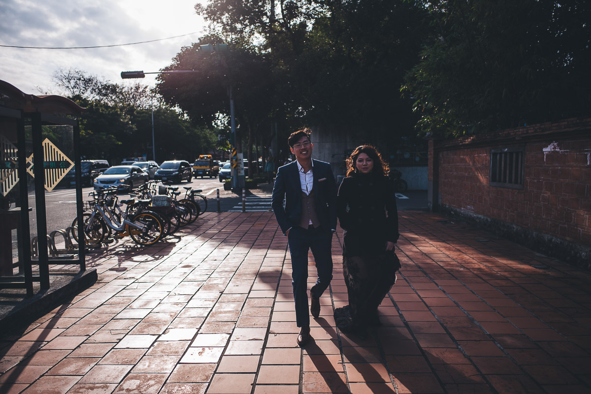 walking through a street with sunlit backdrop