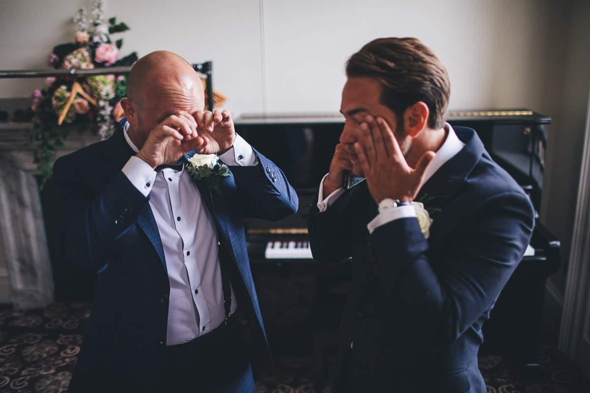 groom and best man crying