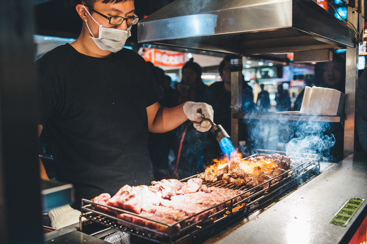 street food stand flame cooking beef steak