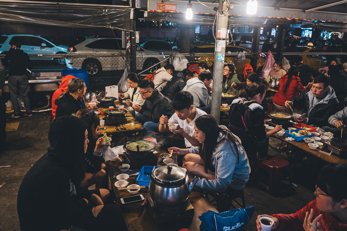 people eating hot pot in night market in taiwan