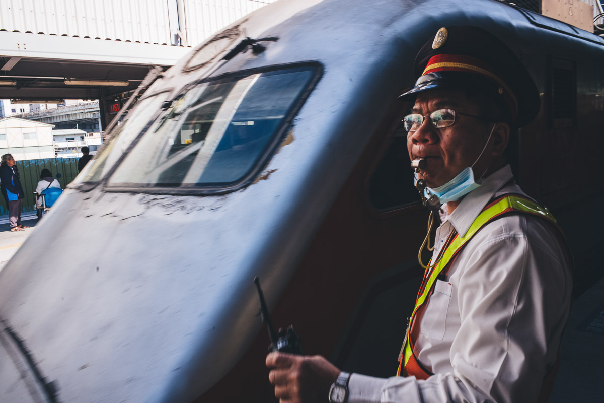 train guard blowing his whistle