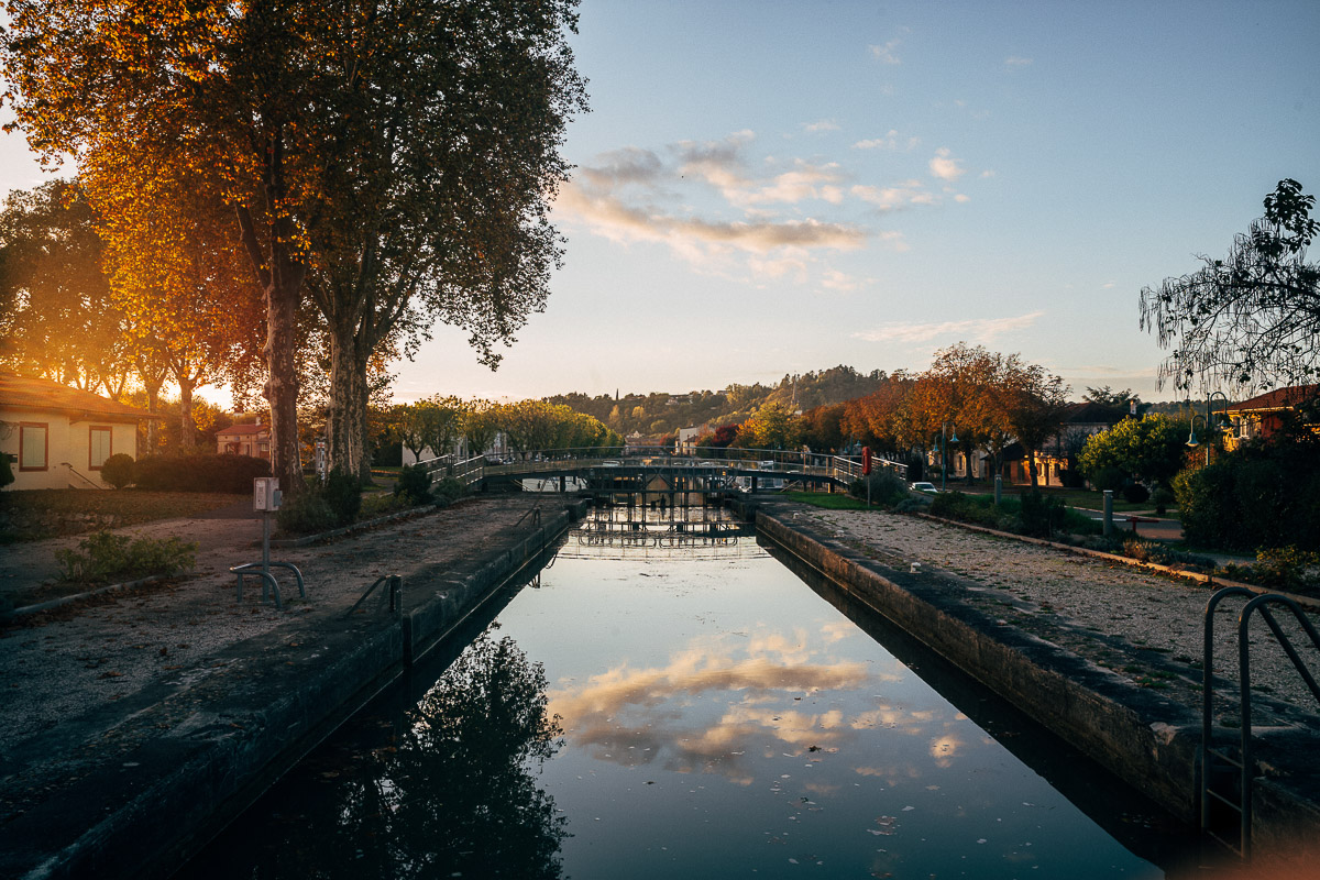 sunset reflection over canal lock in france