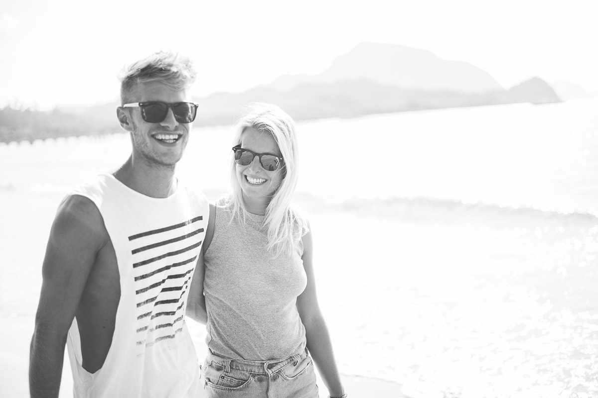 black and white shot of couple wearing sunglasses arm in arm