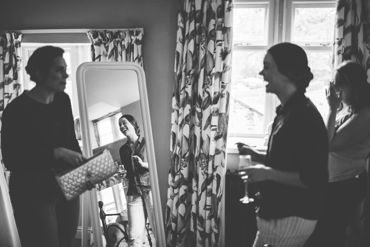 Black and white photo of bride getting ready with her bridesmaids