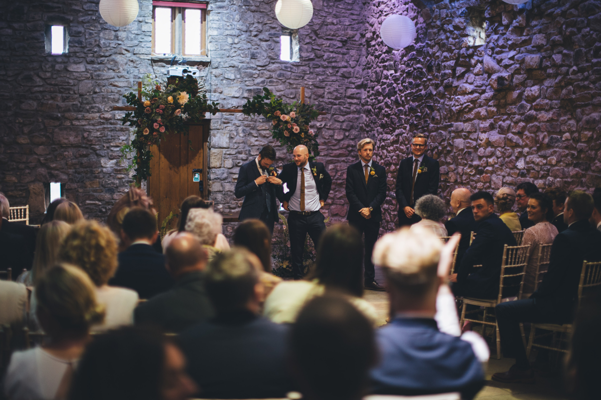 Groom waiting for his bride inside Tithe Barn, Browsholme