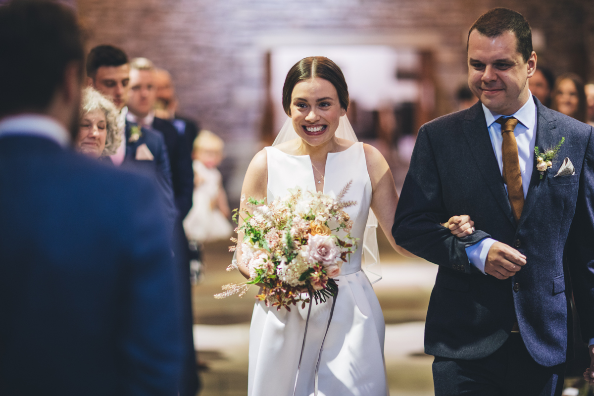 Bride sees groom for the first time as she walks down the aisle
