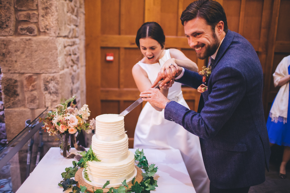 Bride and groom cutting their wedding cake
