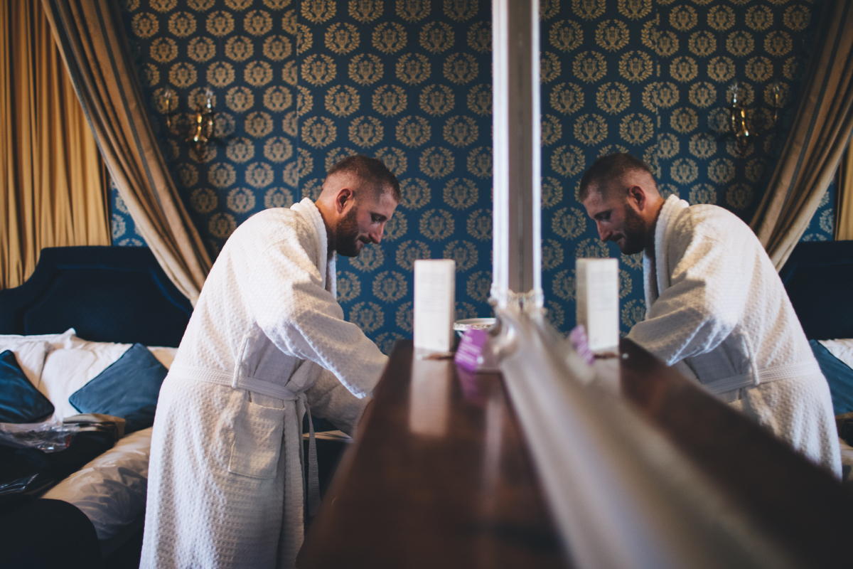 Groom in a dressing gown getting ready for his wedding