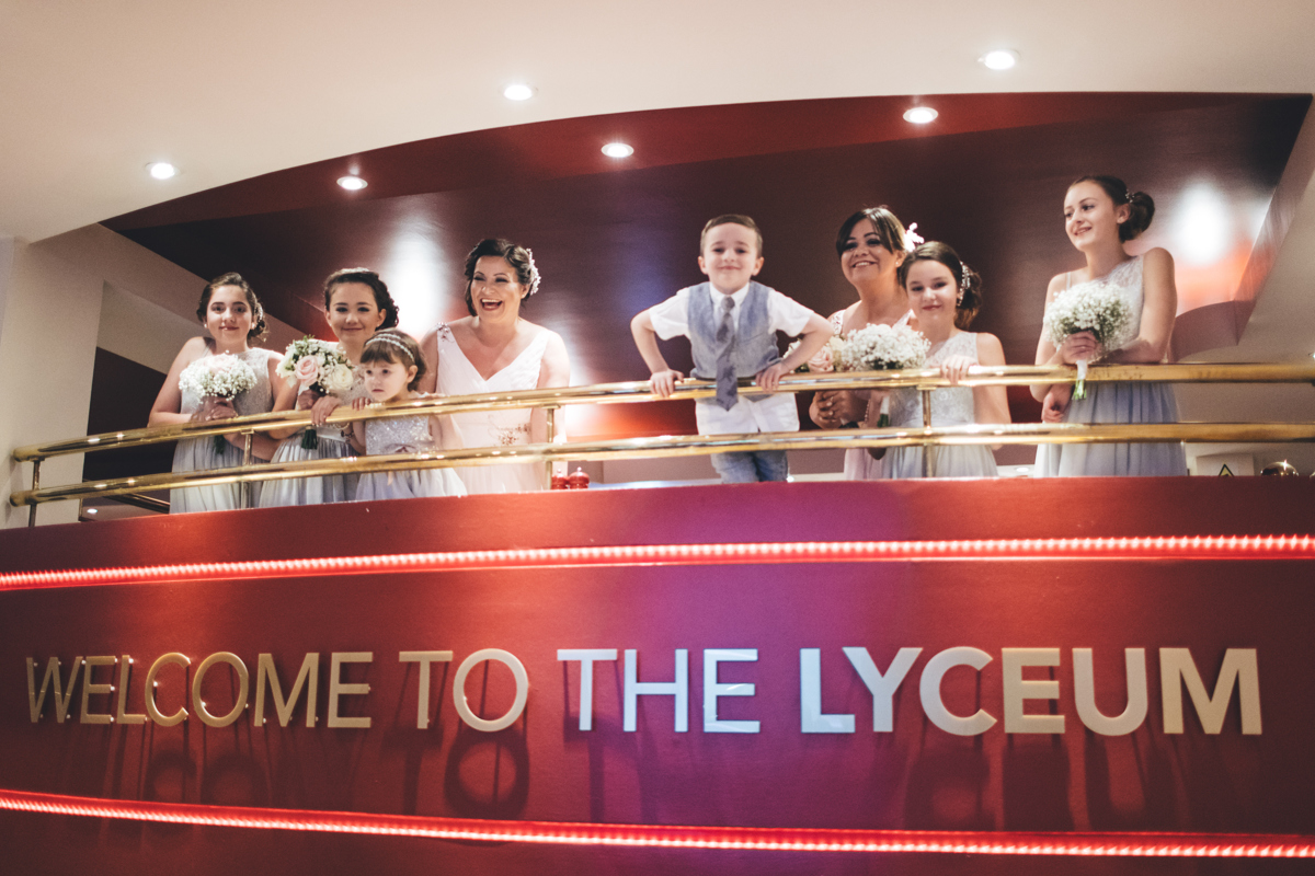 Bridesmaids with flowergirls and a page boy on the balcony at the Lyceum Theatre Wrewe