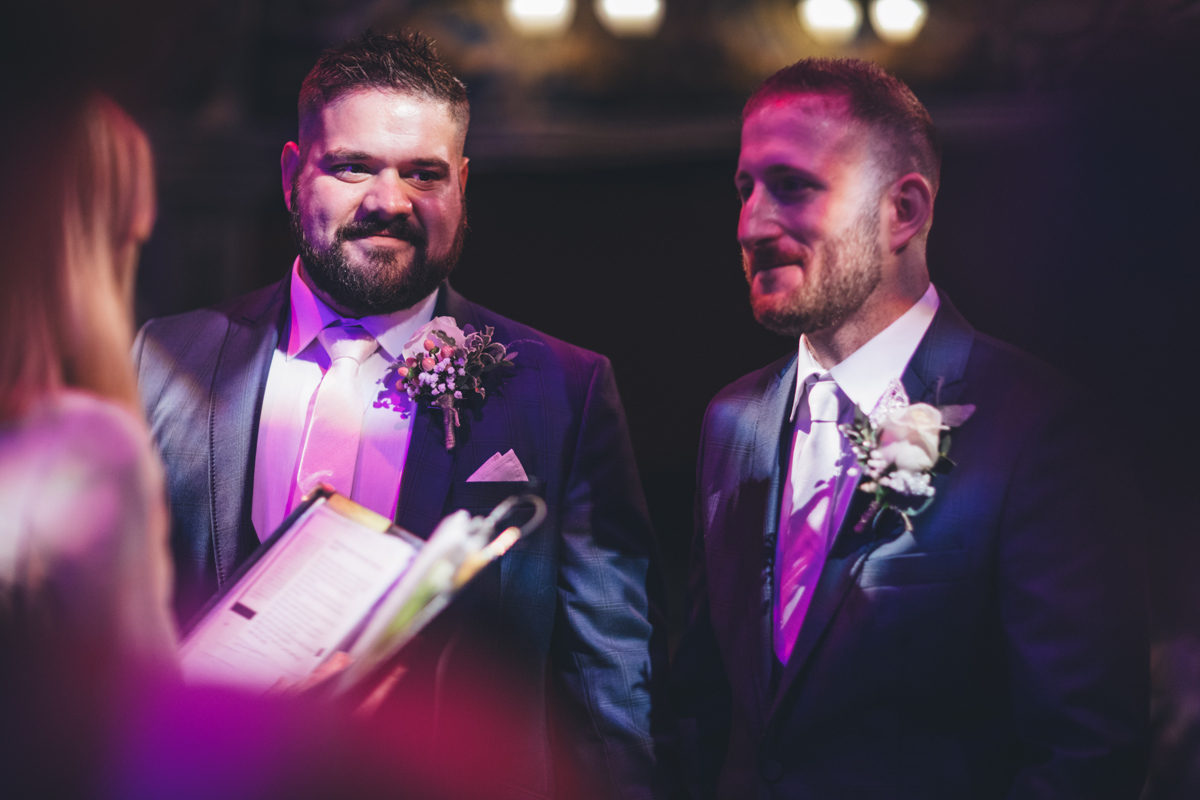 Two grooms stood side by side during their wedding ceremony