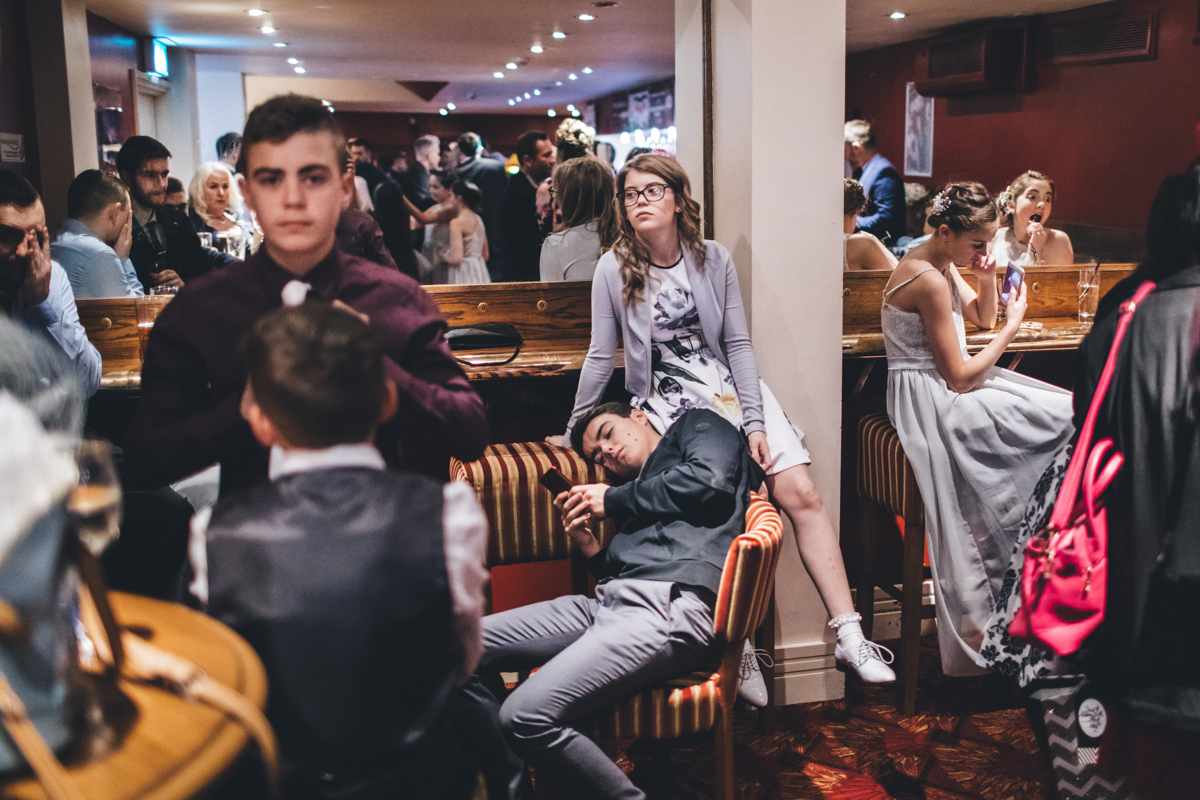 Young members of a wedding party looking bored