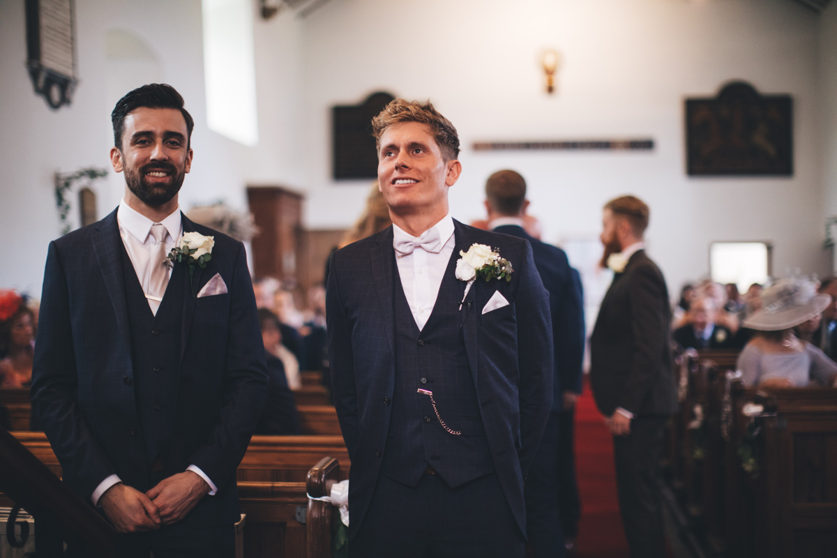 Groom and Best Man waiting nervously at the front of the church