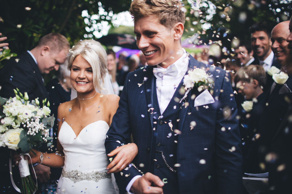 Confetti shot of the Bride and Groom with both of them smiling