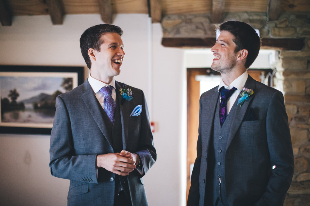 Groom and best man laughing
