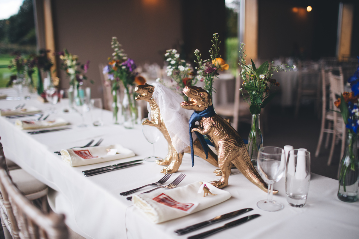 Golden dinosaur place setting for the bride and groom