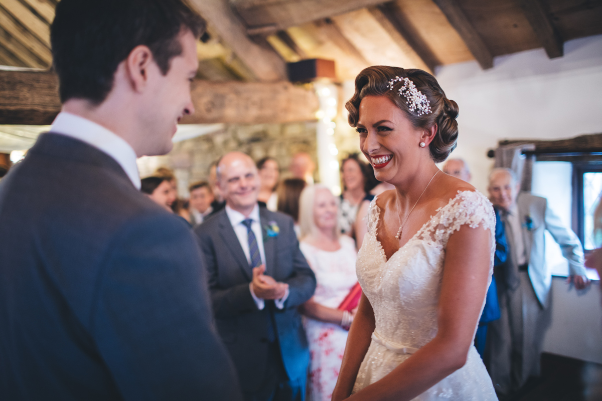 Bride and groom smiling at each other after seeing each other for the first time