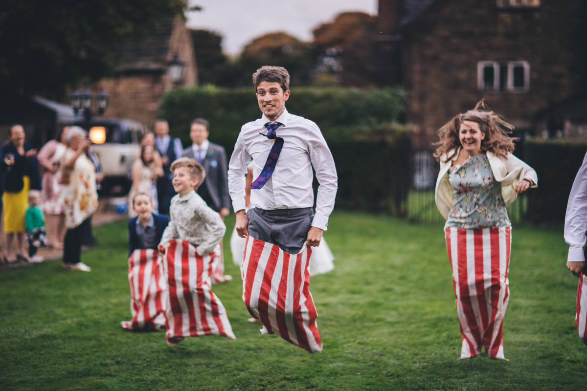 Wedding guests jumping in a sack race