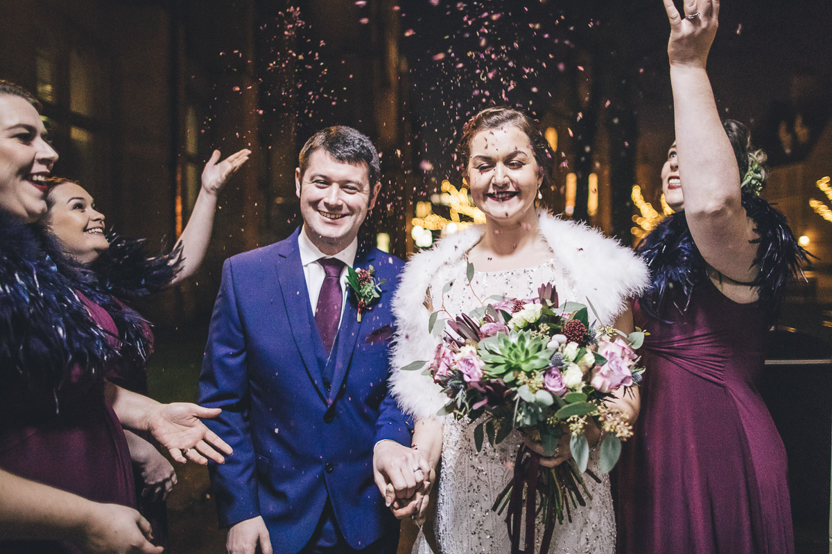 confetti shot of bride, groom and bridesmaids