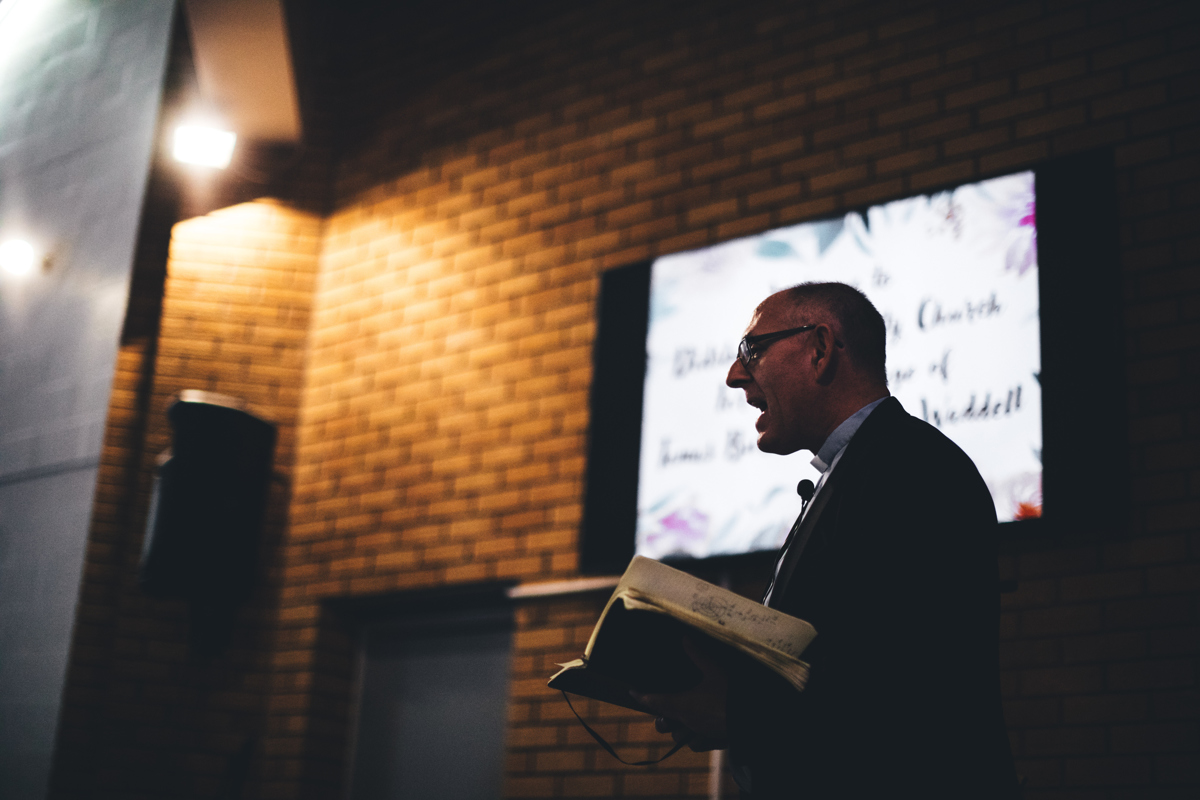 Priest reading from a large book