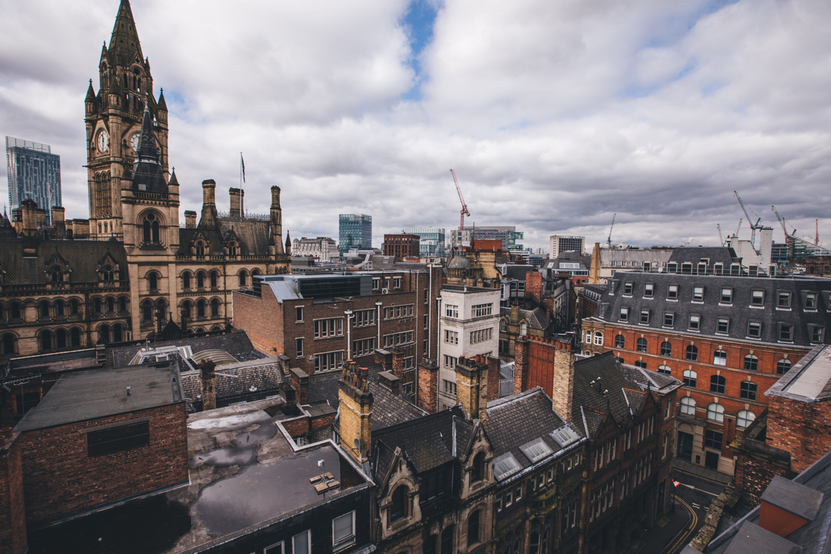 View over the rooftops of Manchester towards the Town Hall from King Street Townhouse